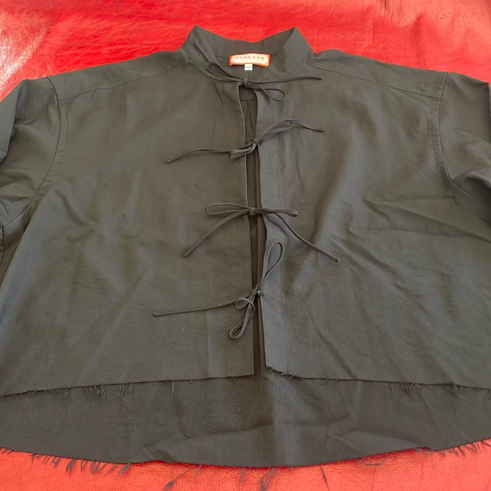 Cropped top with frayed hem line.